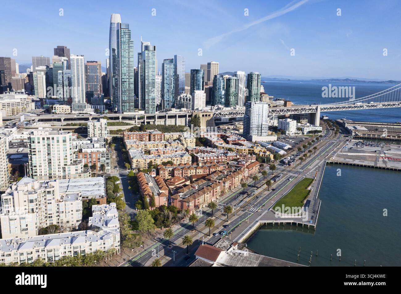 Aerial view of modern skyscrapers towering over terracotta rooftops and ...