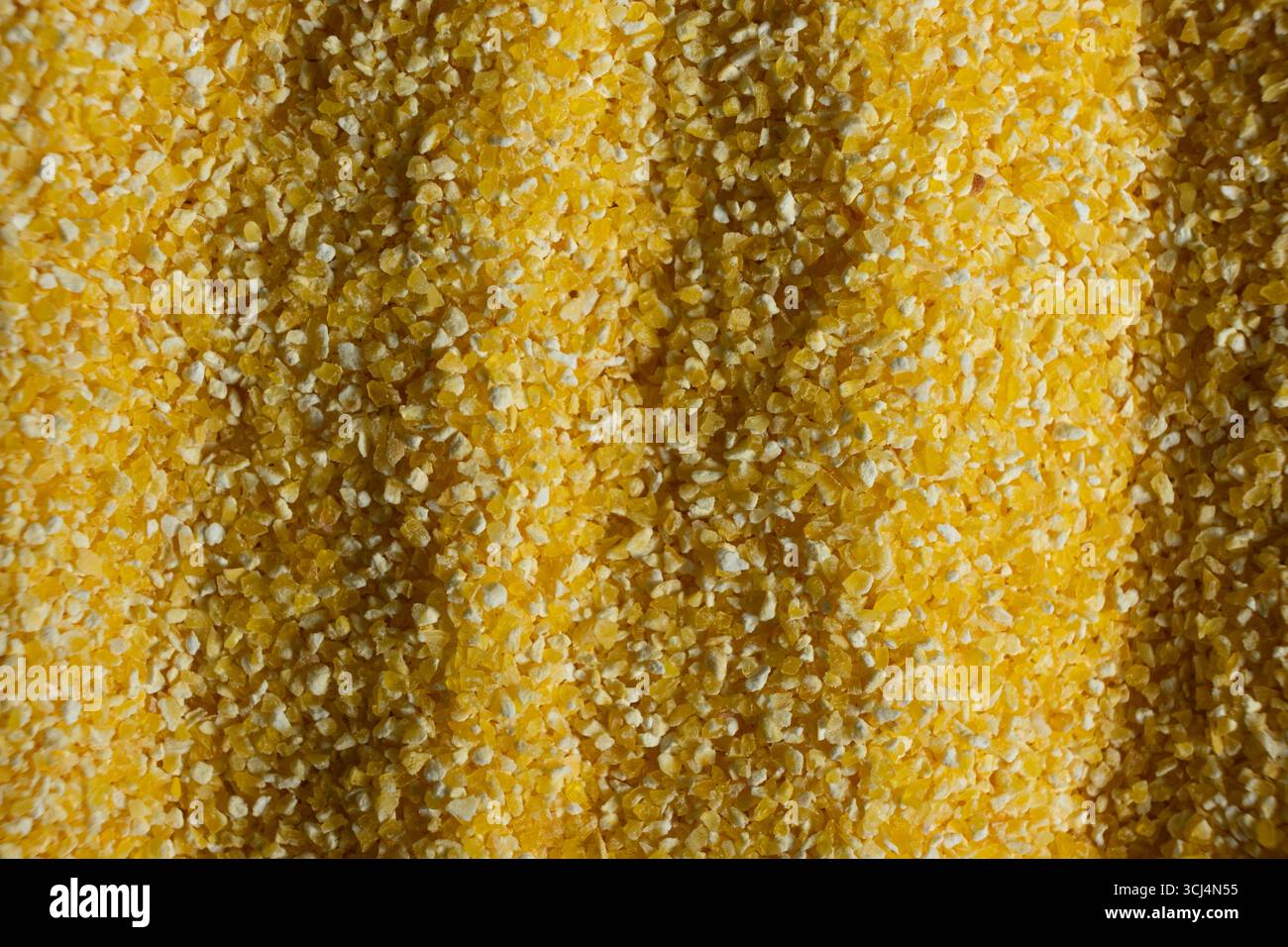 Abstract Yellow Cooking Corn Grits Background. Stock Photo