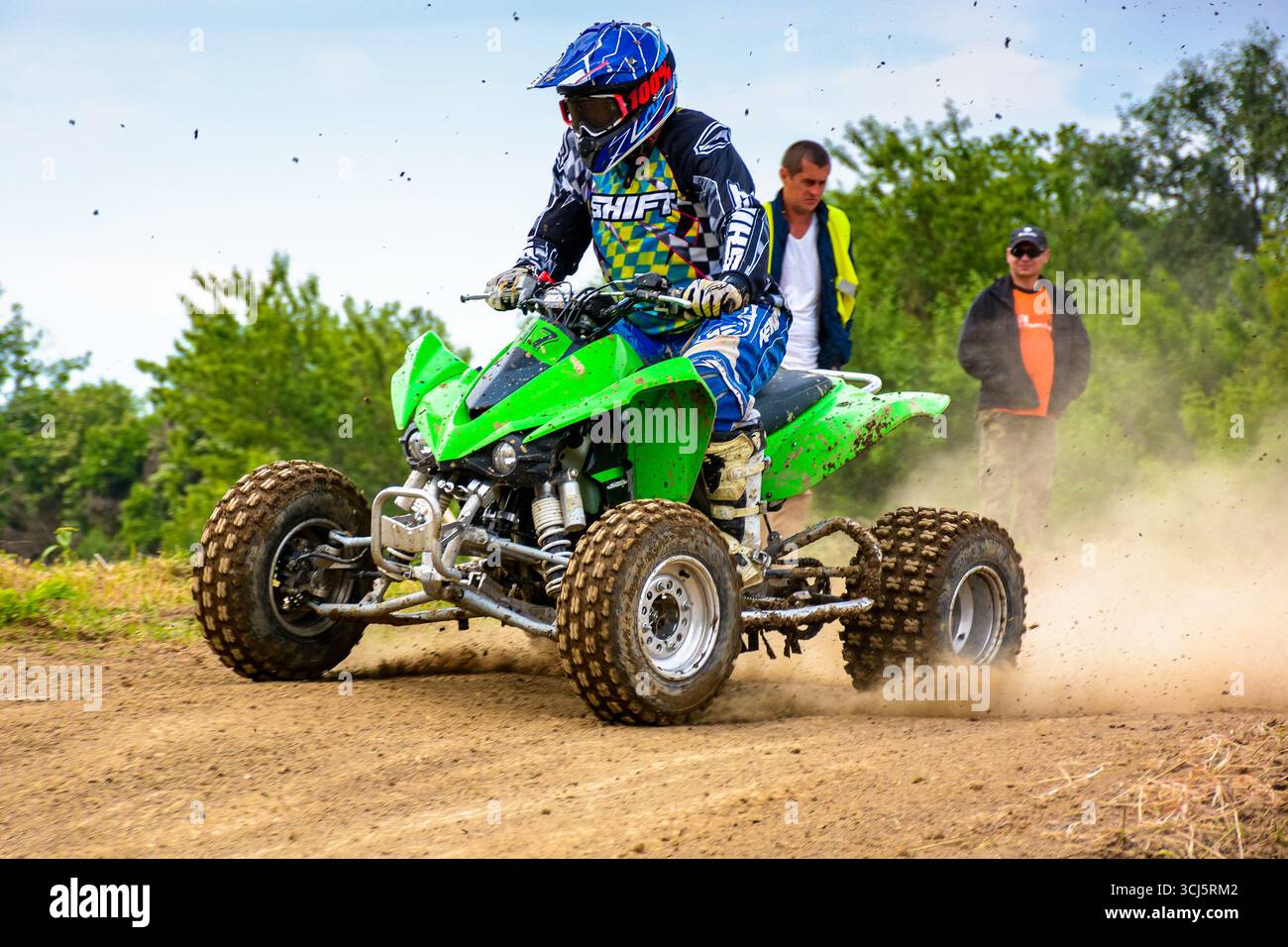 uzhhorod, ukraine - may 21, 2017: ATV rider accelerating on the dirt track. sport competition of green quad wheel vehicle in the mud Stock Photo