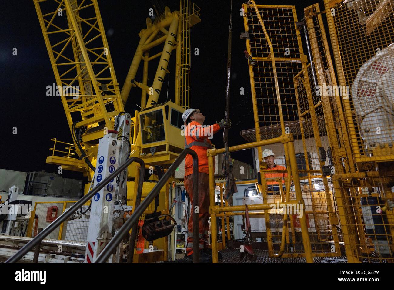 Nick Boehne, right, works the controls of the Expedition 501 wireline ...