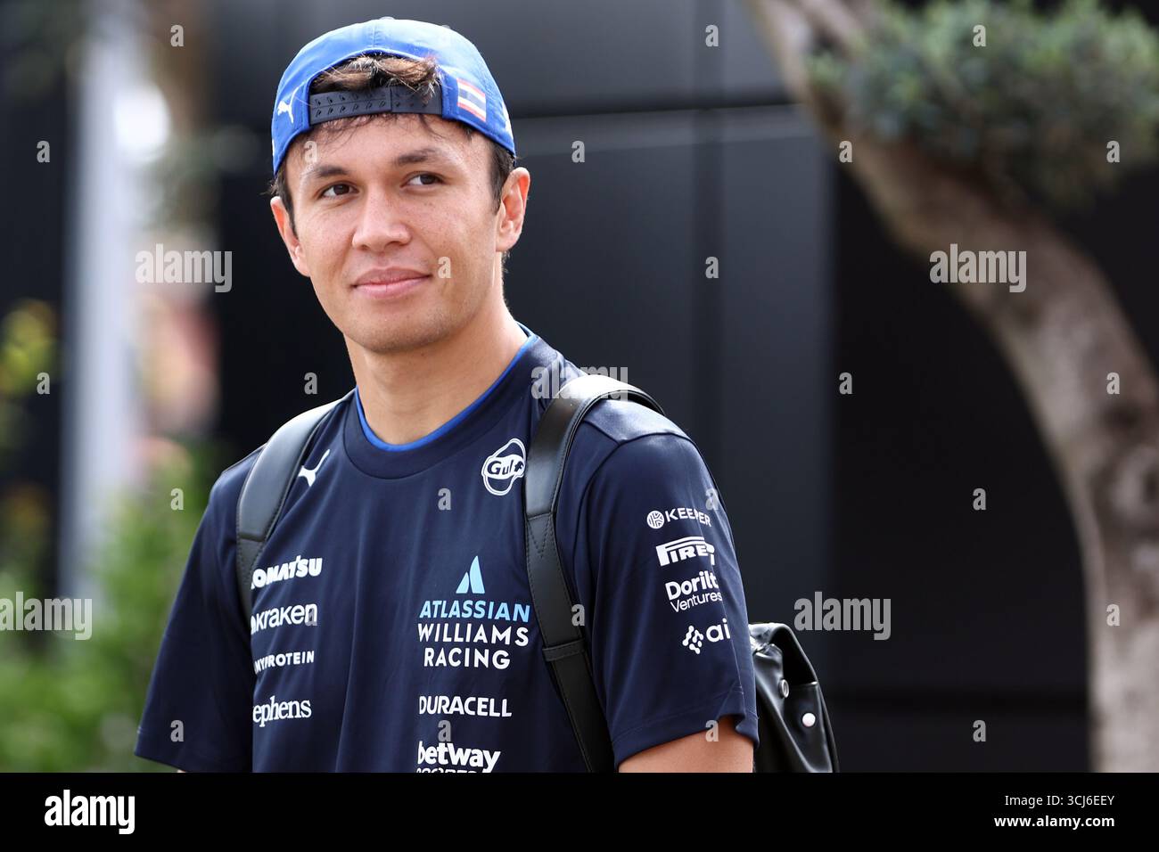 Alexander Albon of Williams Racing looks on in the Paddock during free ...