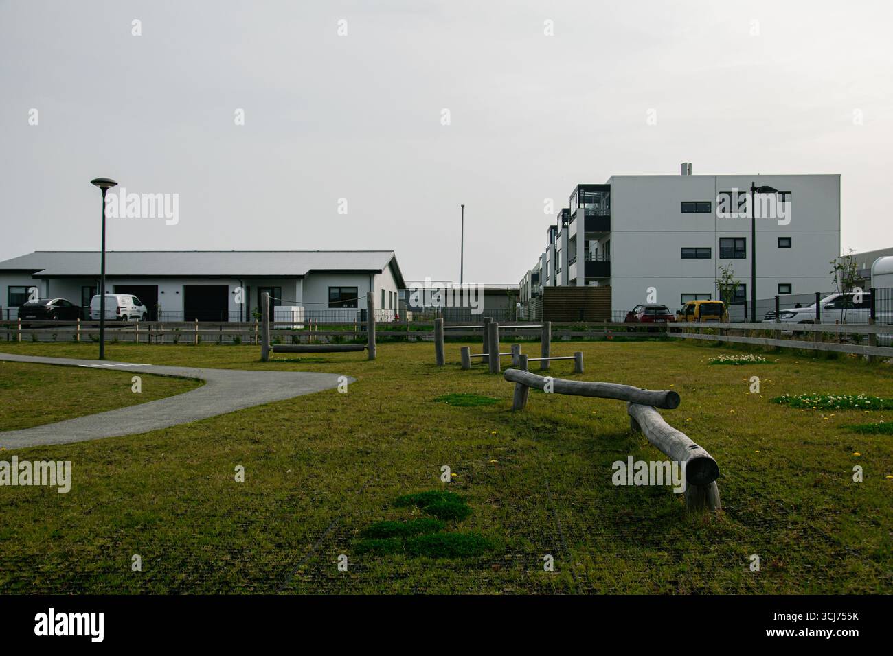 Green open space with walking paths next to modern houses and ... - Iceland Apartments With Creative Open Design