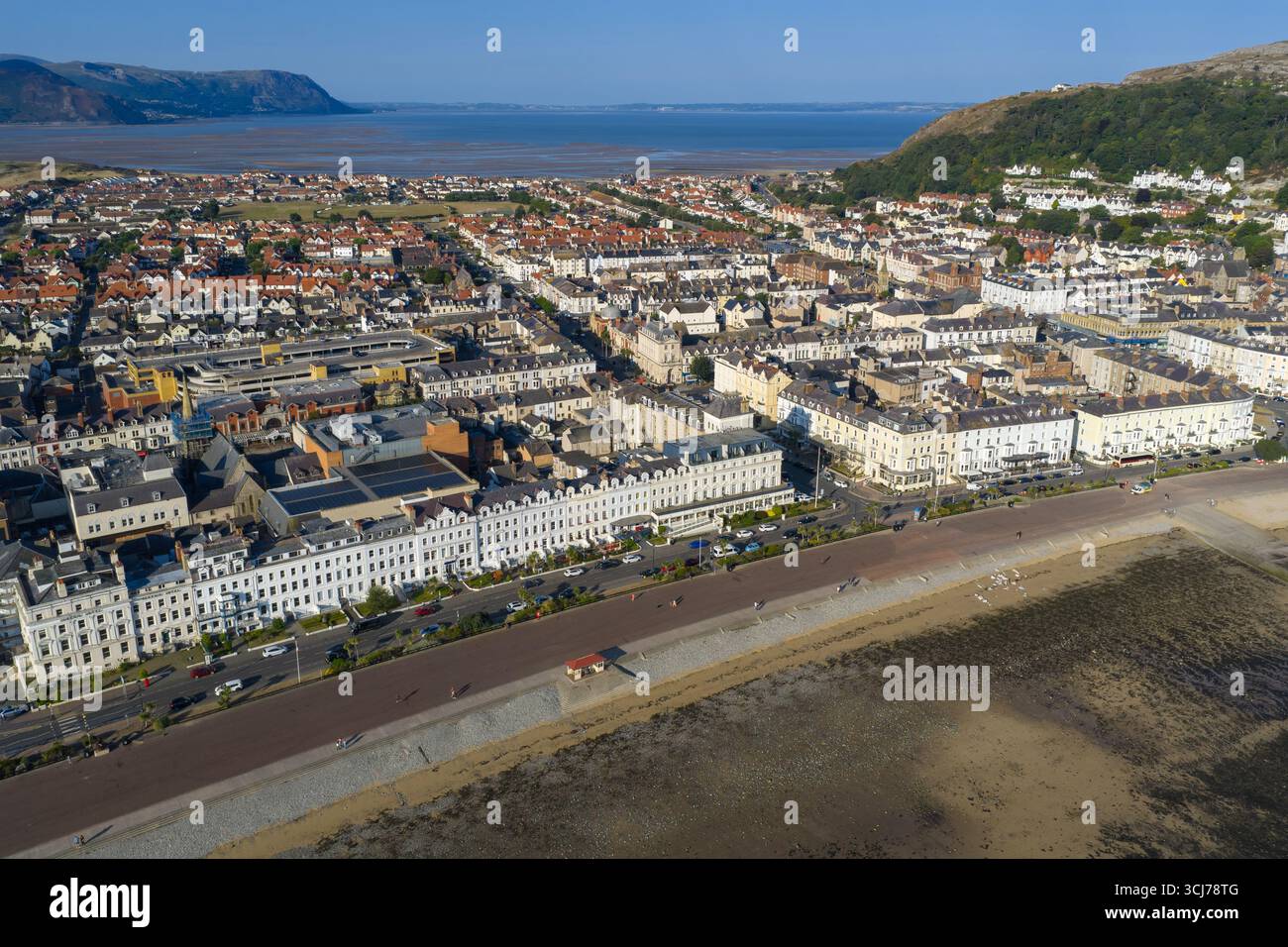 Aerial image of Llandudno, Wales, featuring the sweeping curve of the promenade, and sandy beach at low tide. Stock Photo