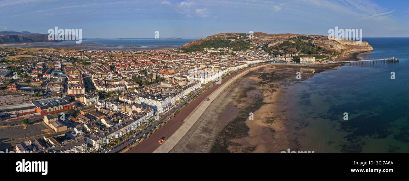 Aerial image of Llandudno, Wales, featuring the sweeping curve of the promenade, and sandy beach at low tide. Stock Photo
