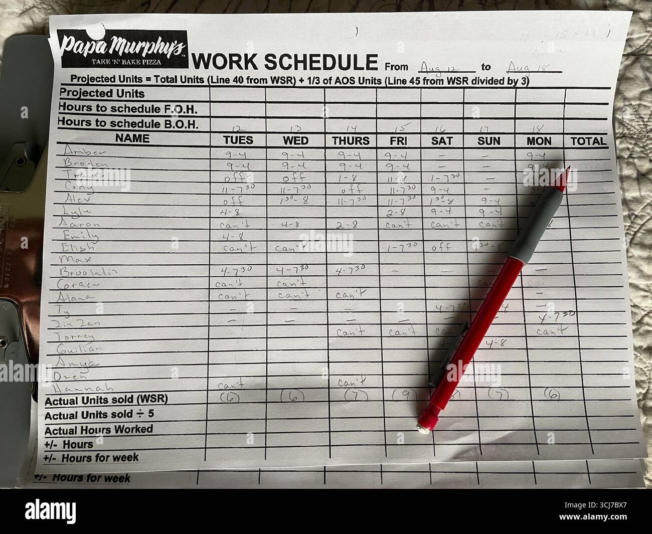 Still life of a fast food pizza take & bake shop work schedule and pencil, 2025, United States - Smartphone Captured Stock Image
