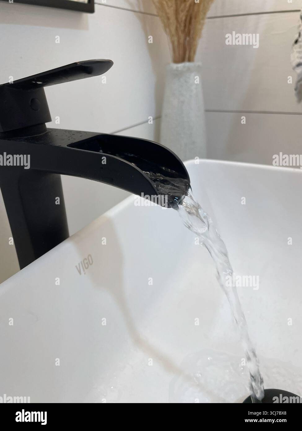 Bathroom Farm Style Sink Faucet with Running Water  2023, USA - Smartphone Captured Stock Image