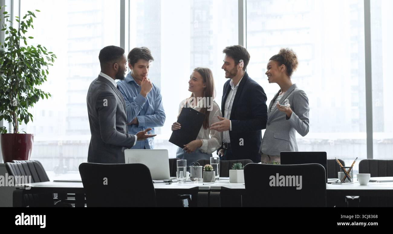 Diverse management team talking in conference room Stock Photo