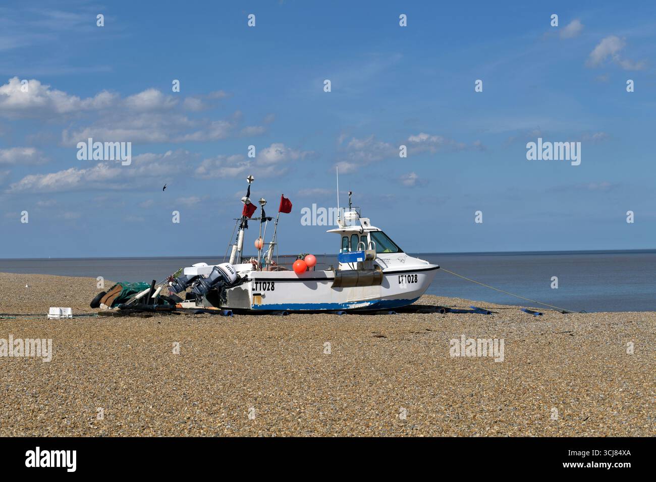 inshore fishing boat beached  on shingle beach, aldeburgh, suffolk, england Stock Photo