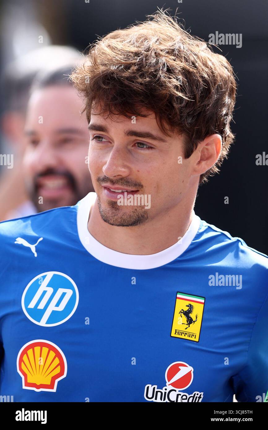 Charles Leclerc of Scuderia Ferrari looks on in the Paddock during