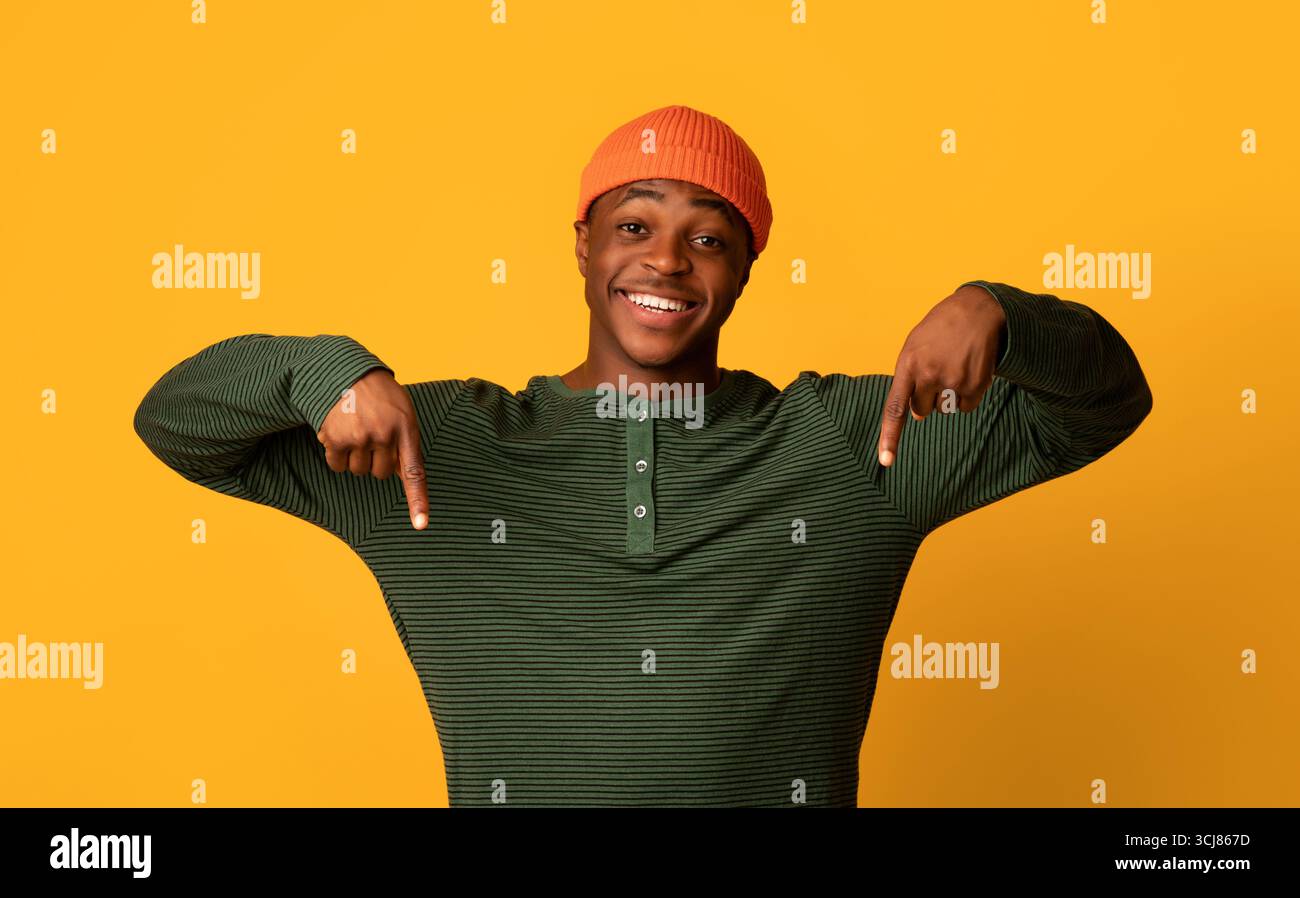 Look At This. Excited Black Guy Pointing Down With Two Hands Stock Photo
