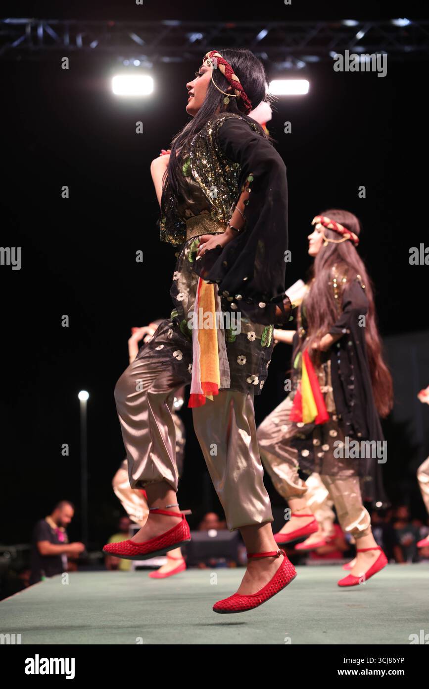 Kurdish girl in traditional dress during dance performance at Damascus ...