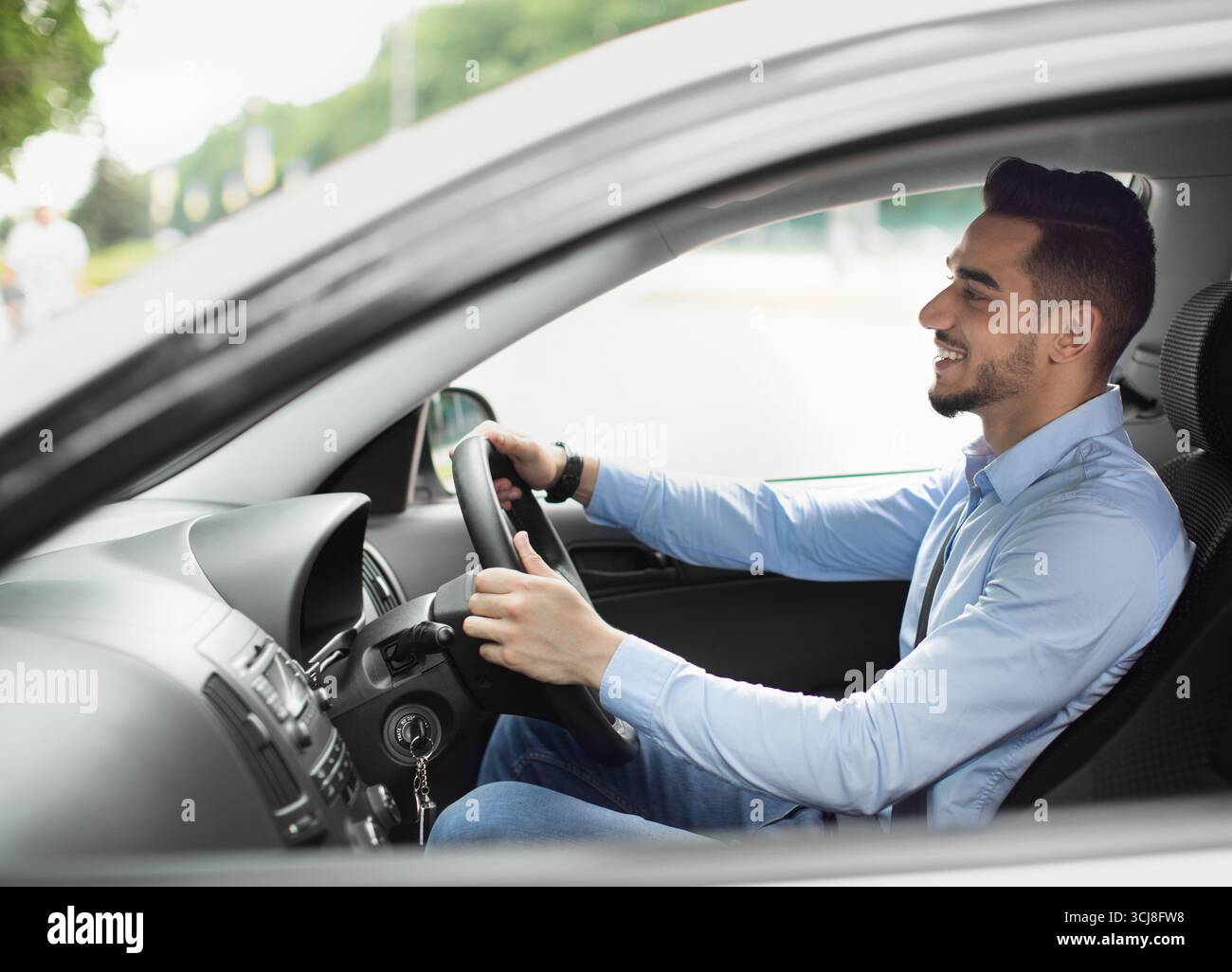 Attractive arabic guy enjoying driving, going to job Stock Photo