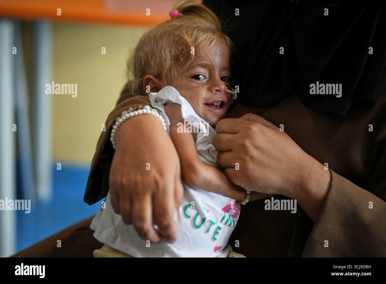 Islam Qudeih holds her daughter, Shamm Qudeih, 2, at the Santobono ...