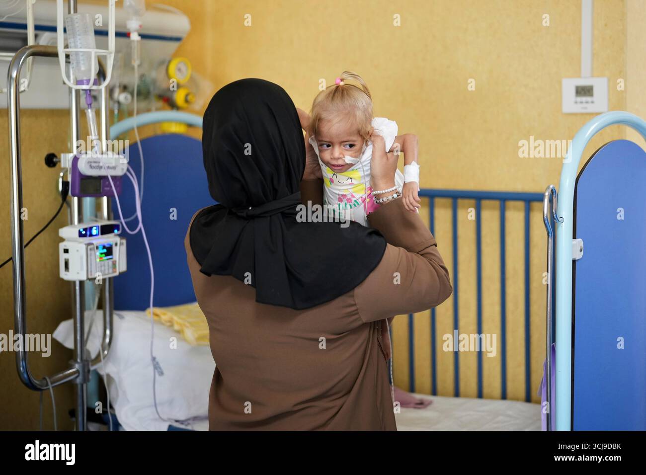 Islam Qudeih holds her daughter, Shamm Qudeih, 2, at the Santobono ...