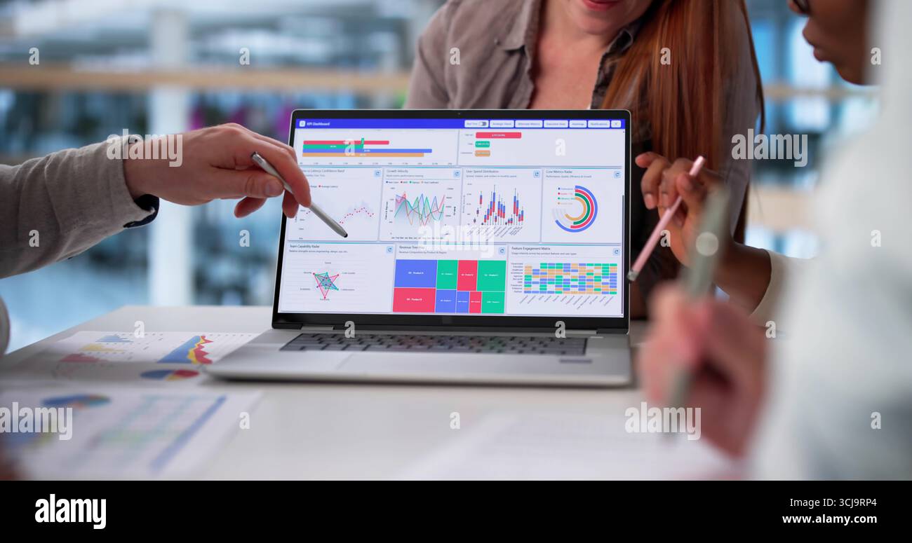 Multicultural Team Analyzing Demographic Data In Collaborative Business Meeting Stock Photo