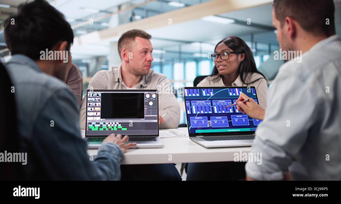Skilled Video Editor Creates Montage Using Web Software On Computer. Stock Photo