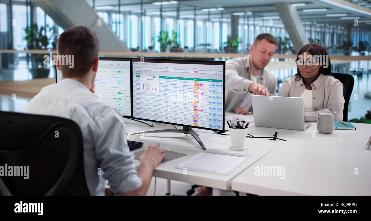 Analyzing Billing Reports With Spreadsheet Software: Diverse Business Team At Work. Stock Photo