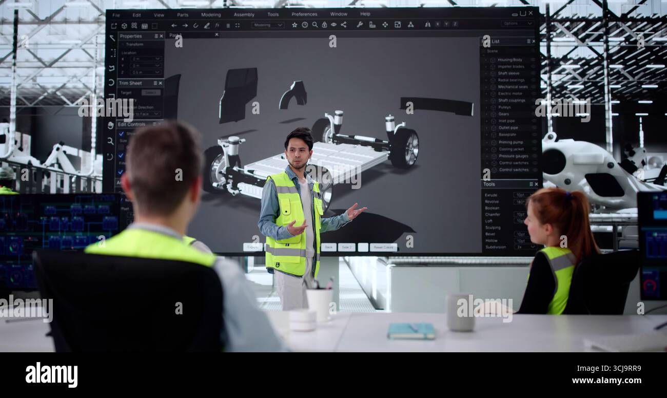 Multiracial Engineering Team Developing Electric Car Model With Precision Sensors Stock Photo