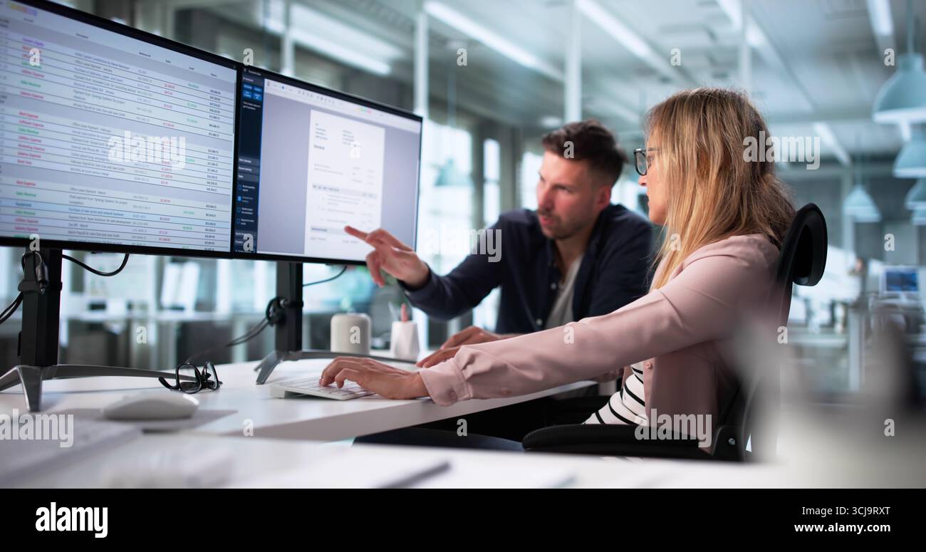 Professional Billing Specialists Working In Office Using Desktop Computer Screen Stock Photo