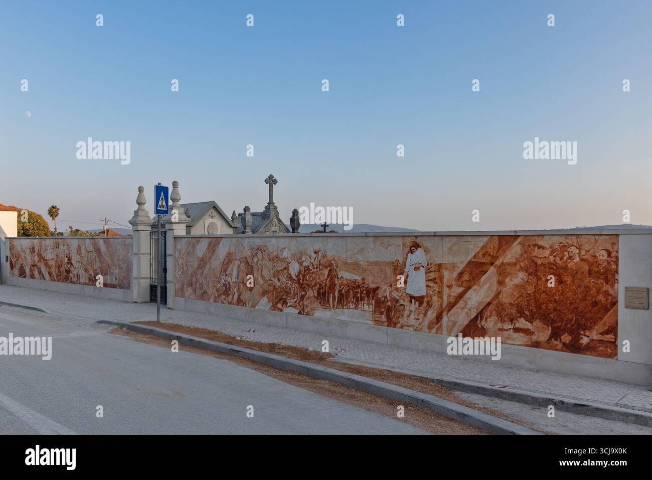 A long mural depicting scenes from the history of Fátima, Portugal. The artwork has a warm, sepia-toned quality. Fatima, Portugal. 5 August 2025. Stock Photo