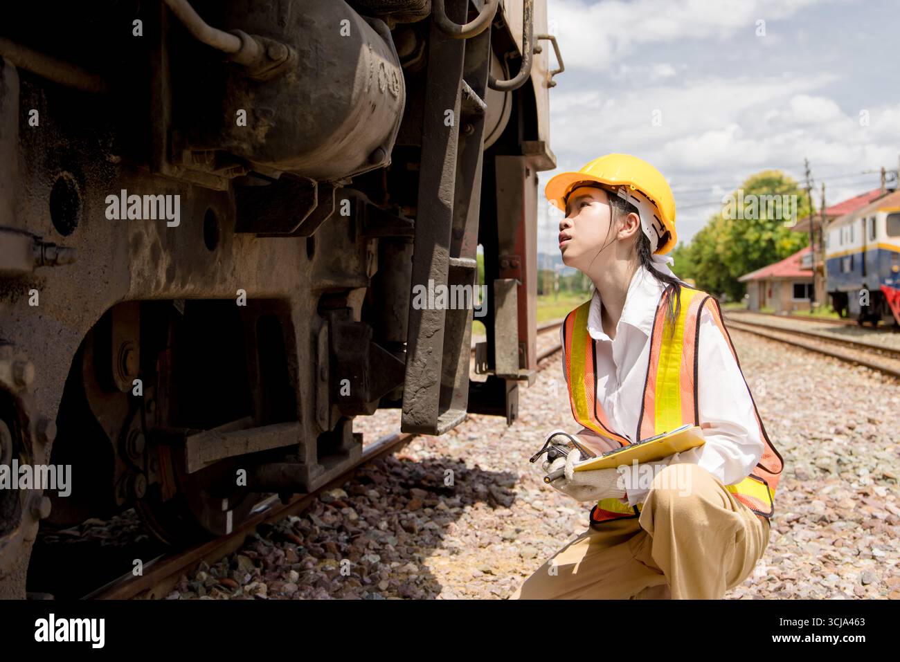 Asian young teen engineer worker work in Train station, Old locomotive ...