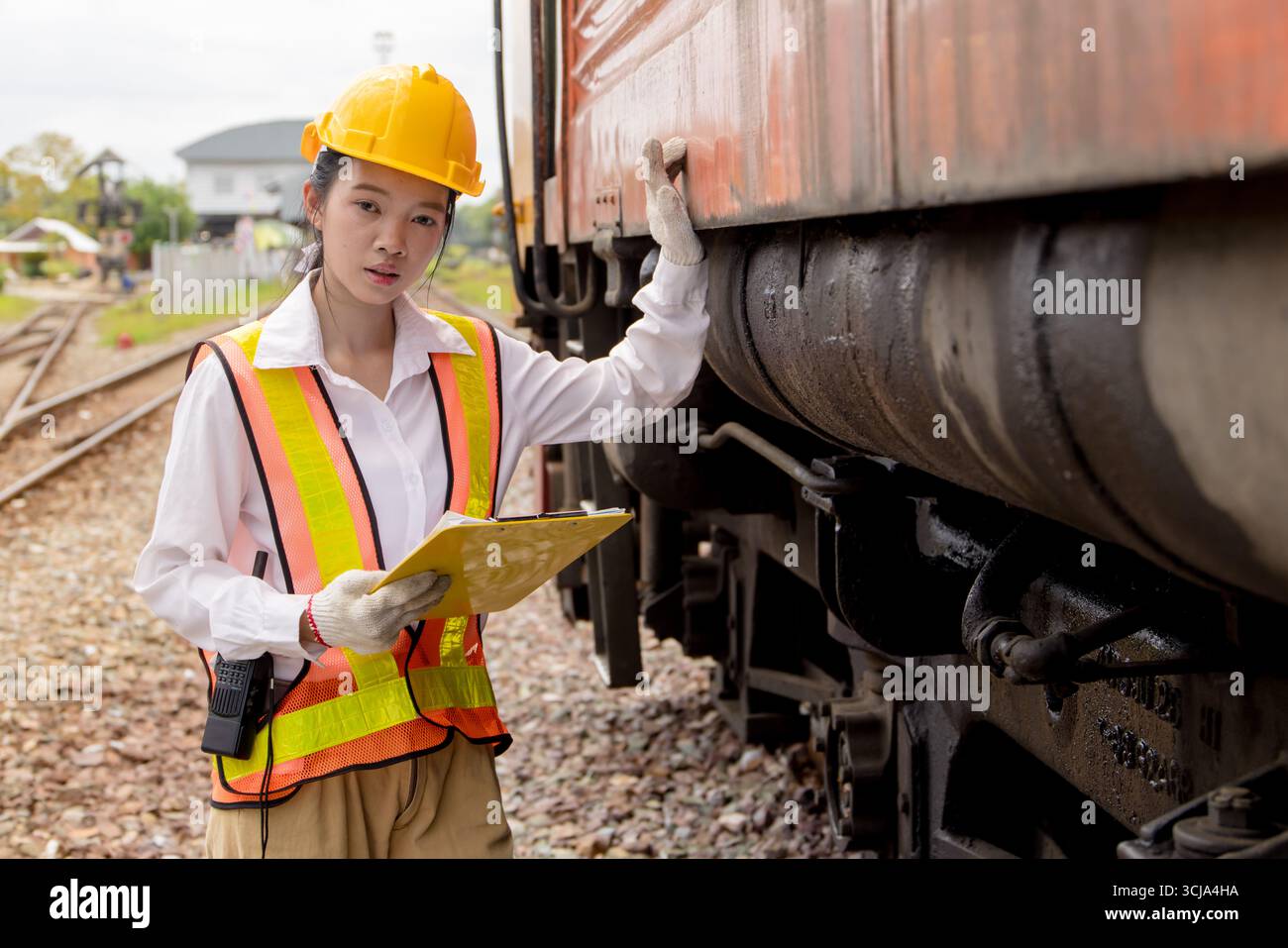 Portrait Asian young teen engineer worker work in Train station ...