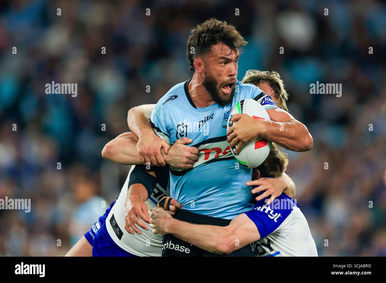 Toby Rudolf of the Sharks is tackled during the NRL Round 27 match ...
