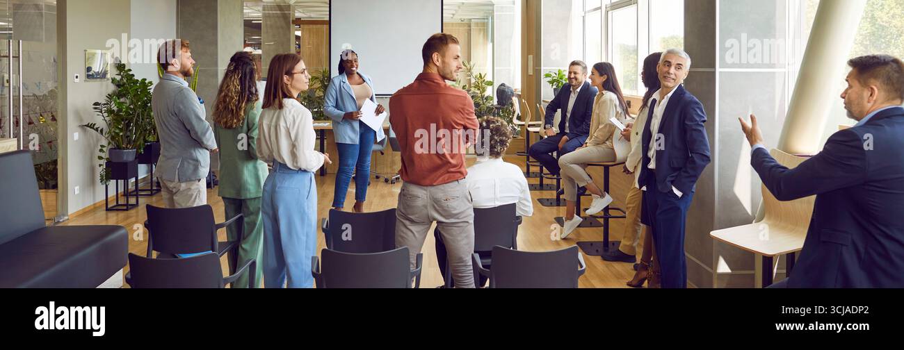 Group of business men and women meeting in office and learning to make public speeches Stock Photo