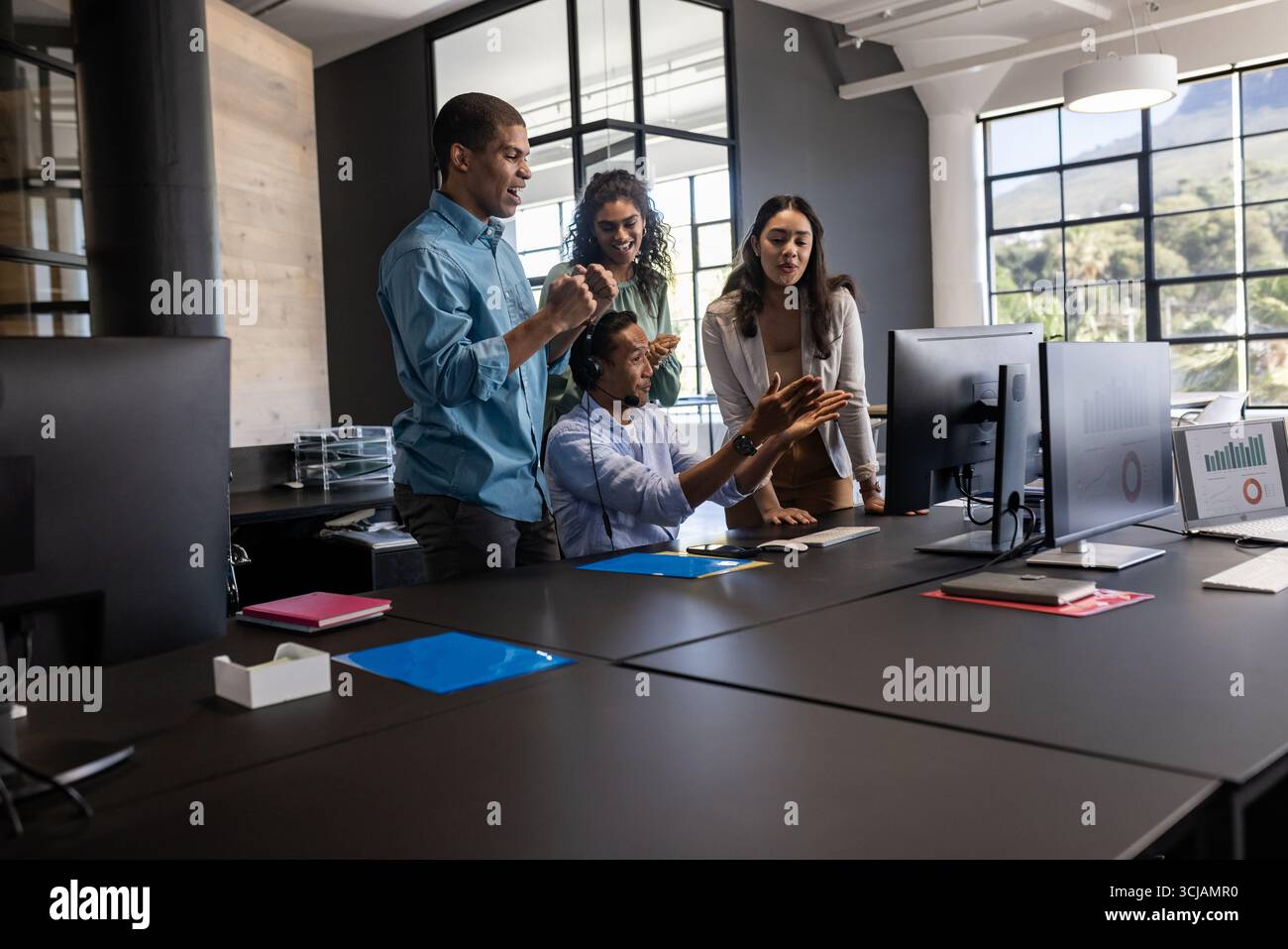 Business team collaborating at office, discussing project on computer screen Stock Photo