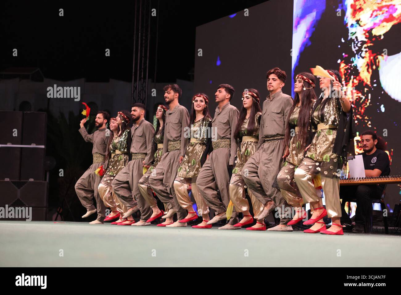 A Kurdish traditional dance troupe performs during the Damascus ...