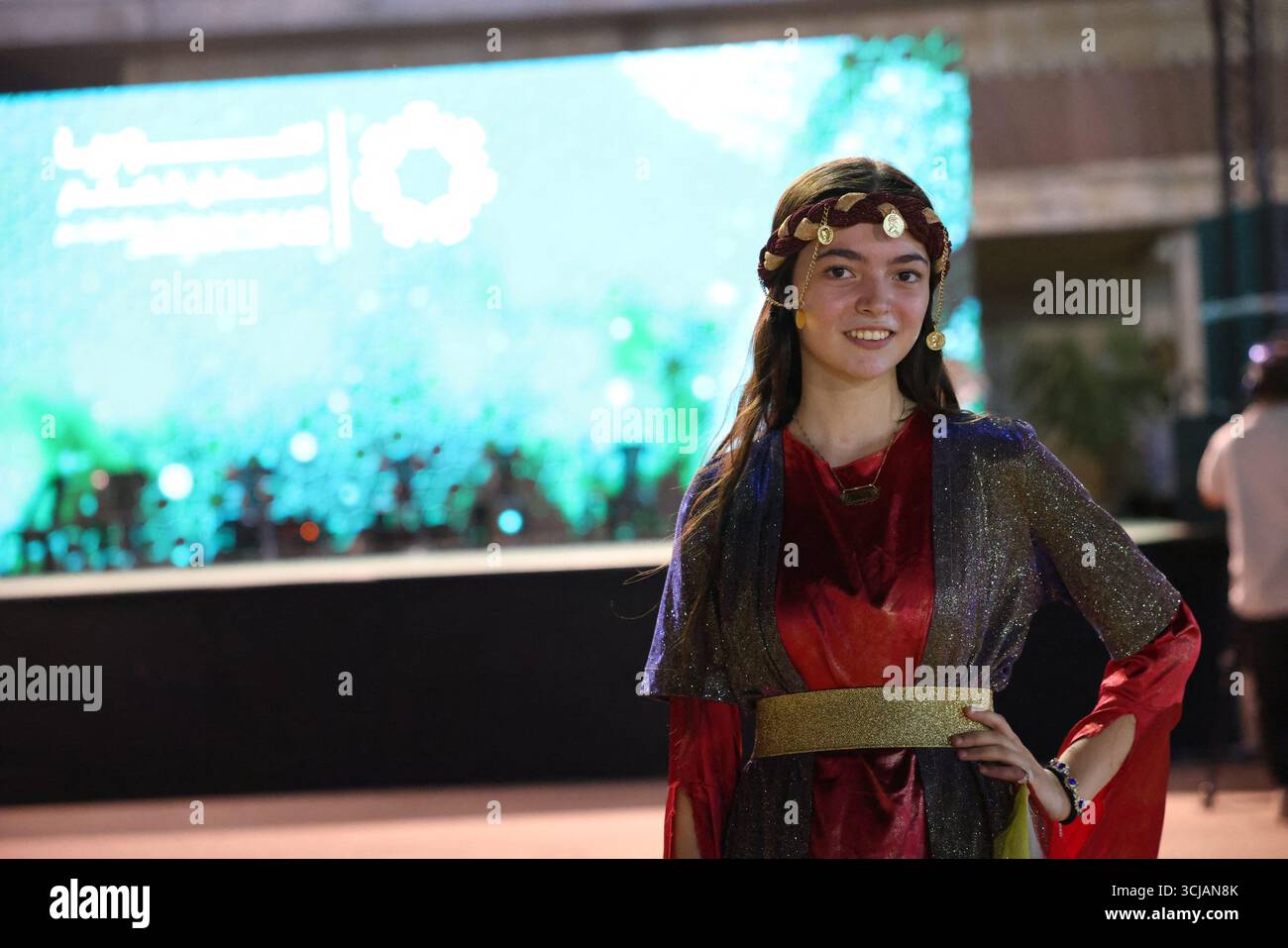 A Kurdish girl dressed in traditional costume takes part in a Kurdish ...