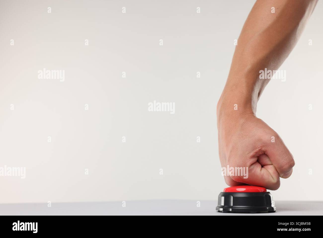 Man pressing red button on white background, closeup. Space for text Stock Photo