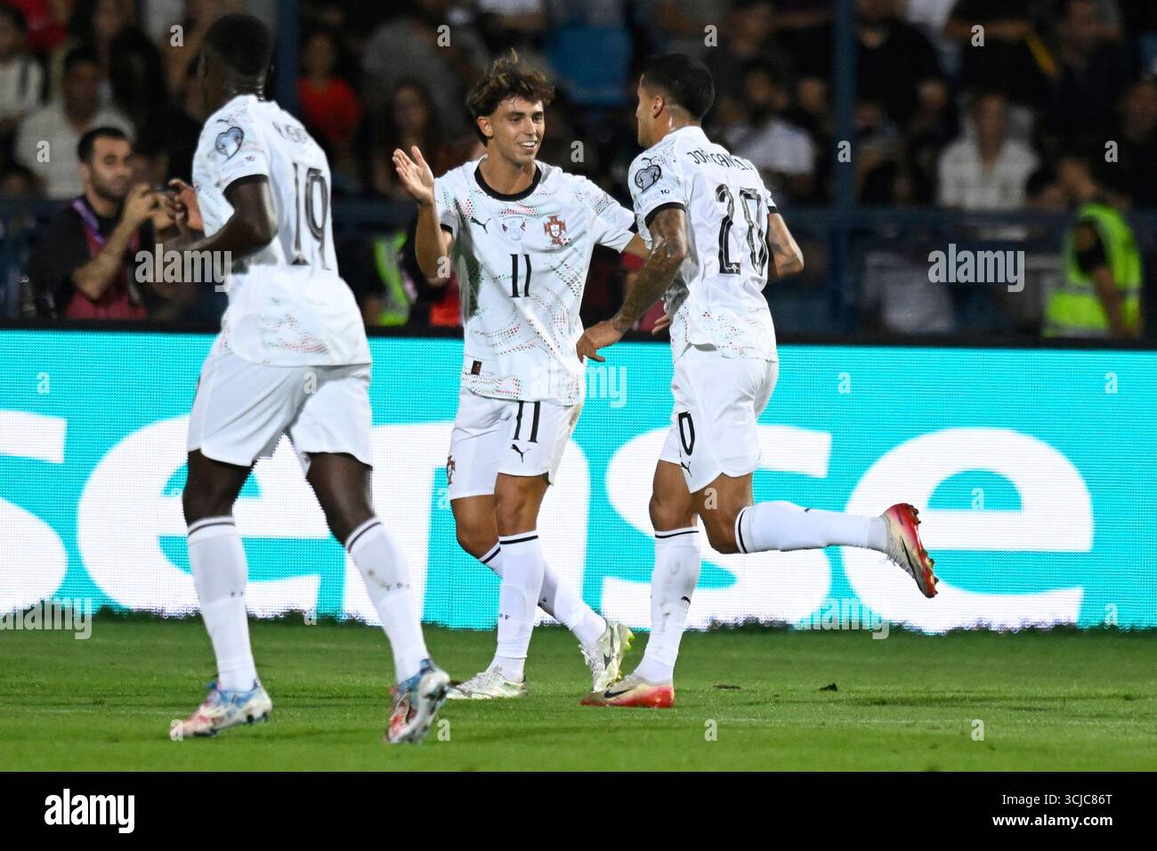 Portugal's Joao Cancelo, right, celebrates with Joao Felix after