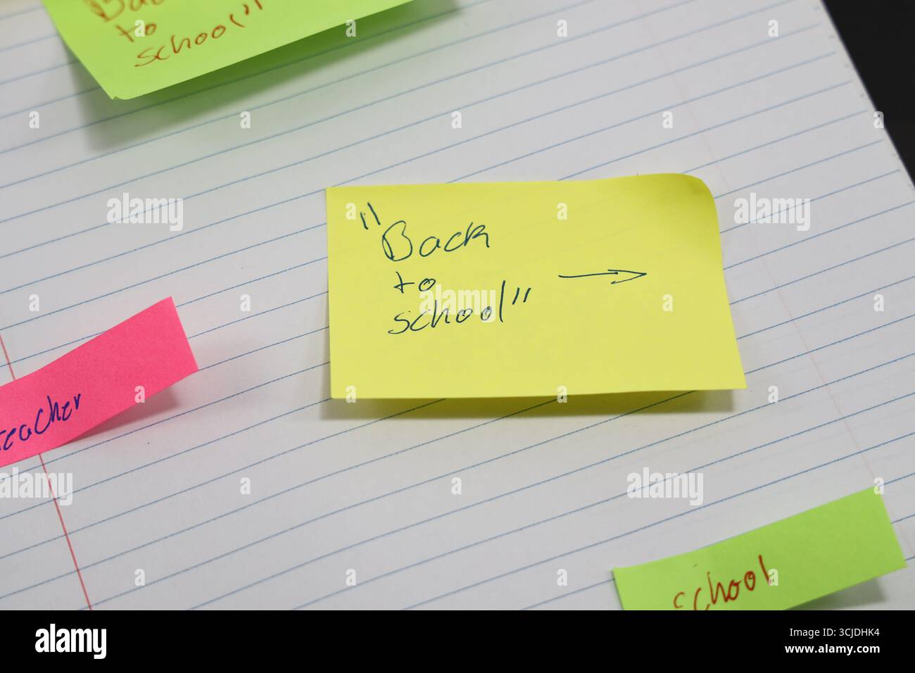 sticky notes stuck to a school notebook written on them student teacher school homework Stock Photo