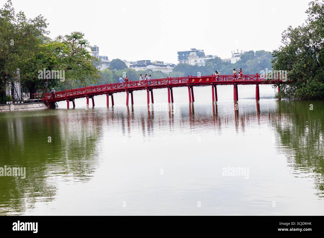 To enter the  Ngoc Son Temple, you need to cross The Huc Bridge. Built in 1865, this red bridge made of wood connects the bank with Ngoc Son Temple in Stock Photo