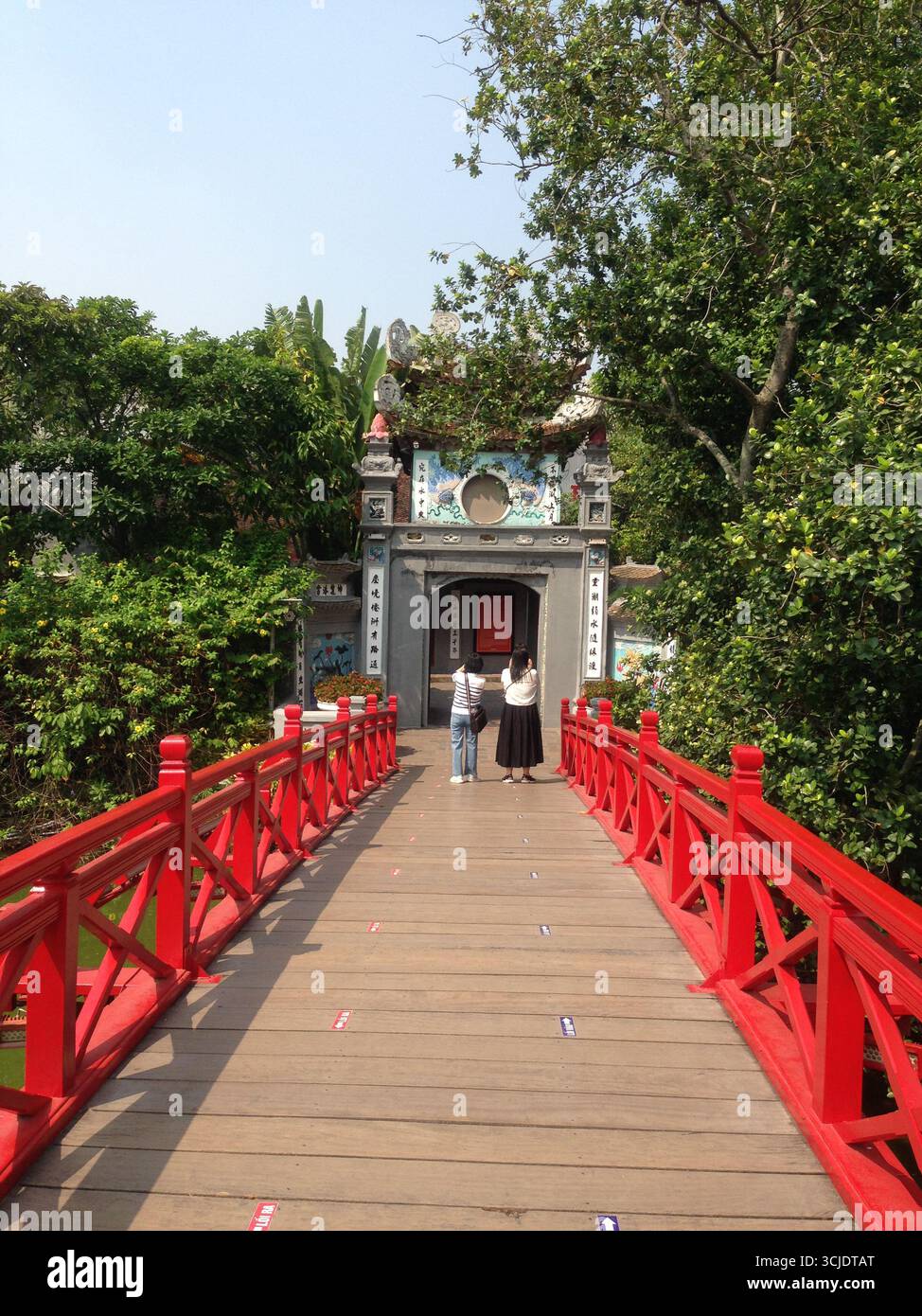 To enter the  Ngoc Son Temple, you need to cross The Huc Bridge. Built in 1865, this red bridge made of wood connects the bank with Ngoc Son Temple in Stock Photo