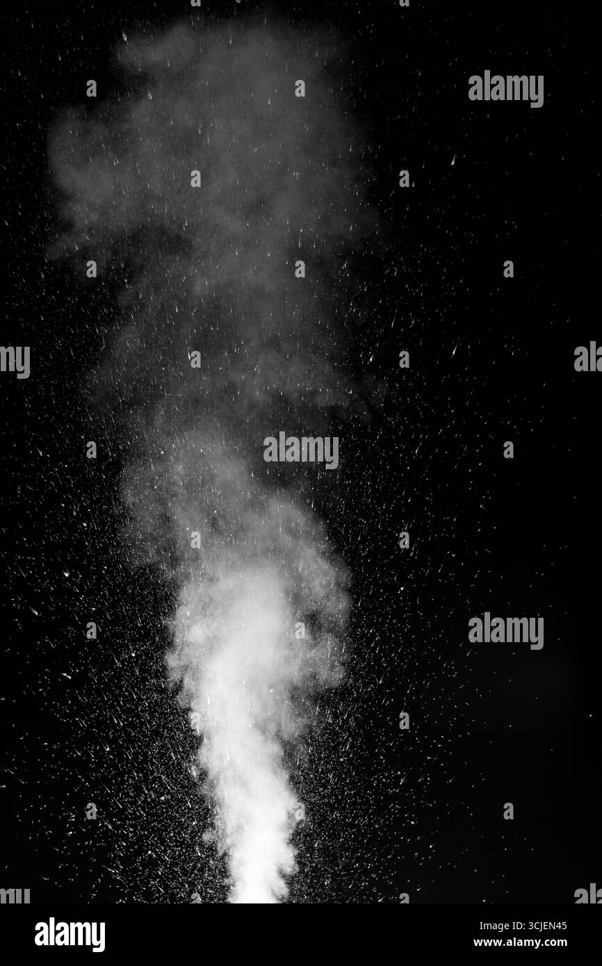 Dense white smoke or steam rising vertically in a dark environment. Swirling, writhing smoke to overlay on your photos. evoking mystery, motion, and a Stock Photo