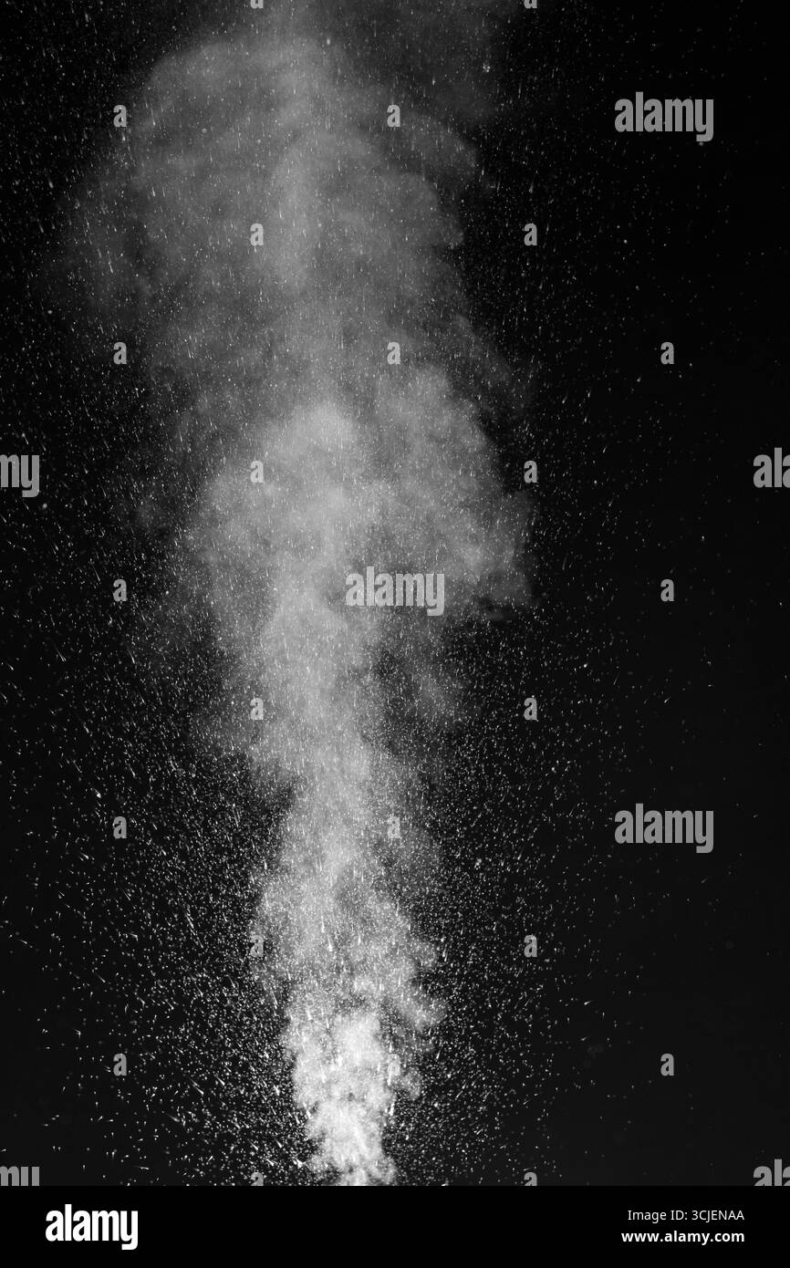 Dense white smoke or steam rising vertically in a dark environment. Swirling, writhing smoke to overlay on your photos. evoking mystery, motion, and a Stock Photo