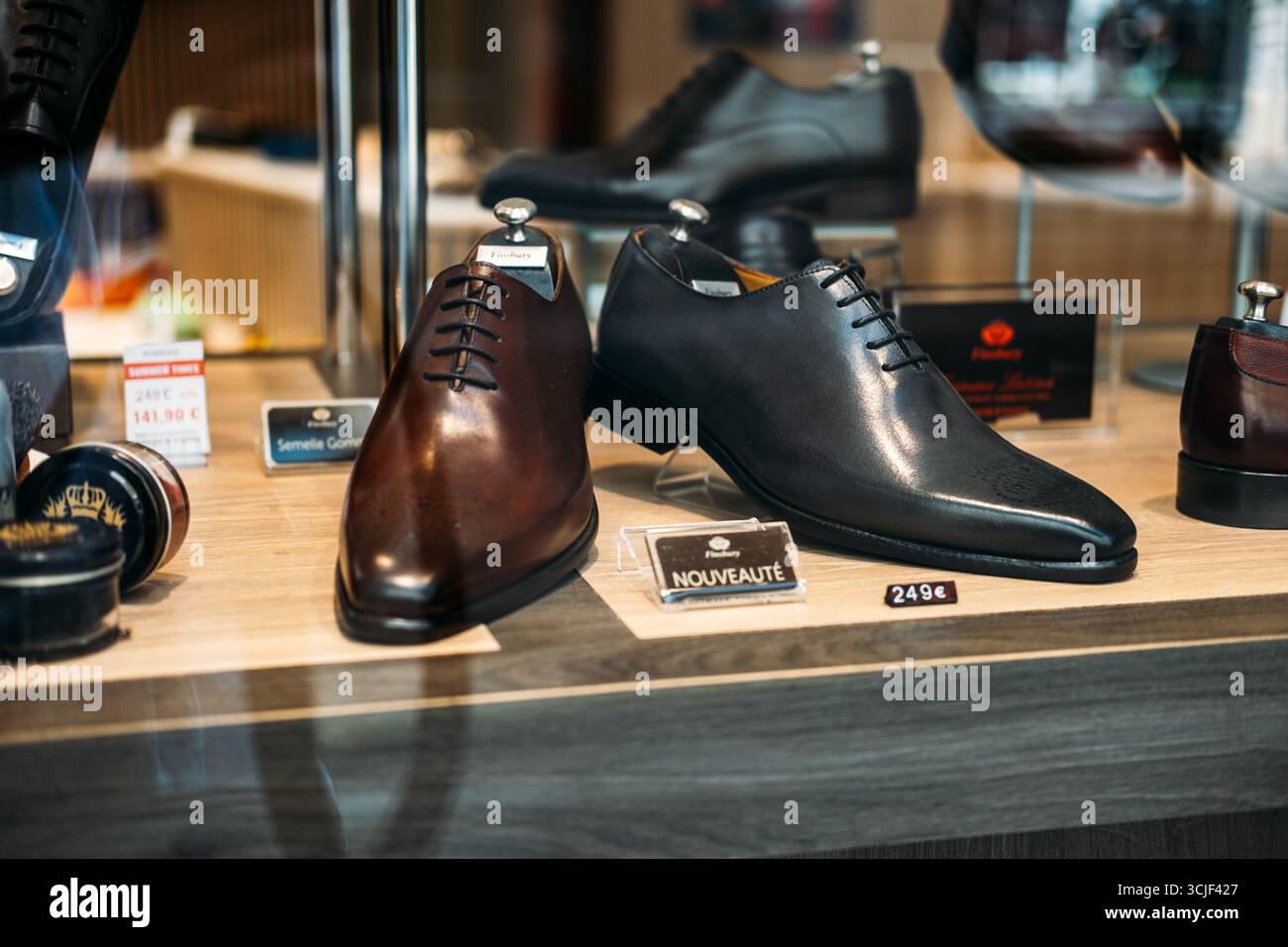 Luxury mens leather dress shoes in brown and black on display in boutique  store window with price tags and shoe care accessories Lyon France August  19 Stock Photo - Alamy