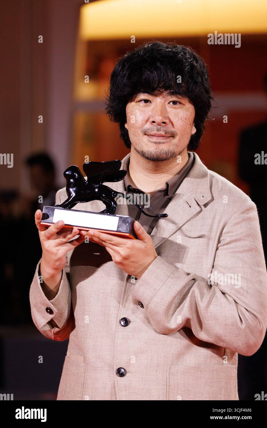 Akio Fujimoto poses with the Orizzonti Special Jury Prize for