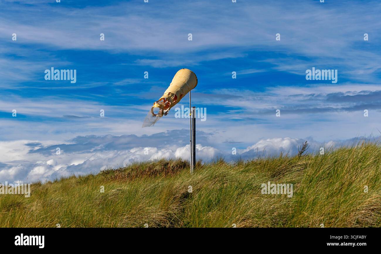 Findhorn Forres Moray Scotland blue sky the tattered wind sock in summer Stock Photo