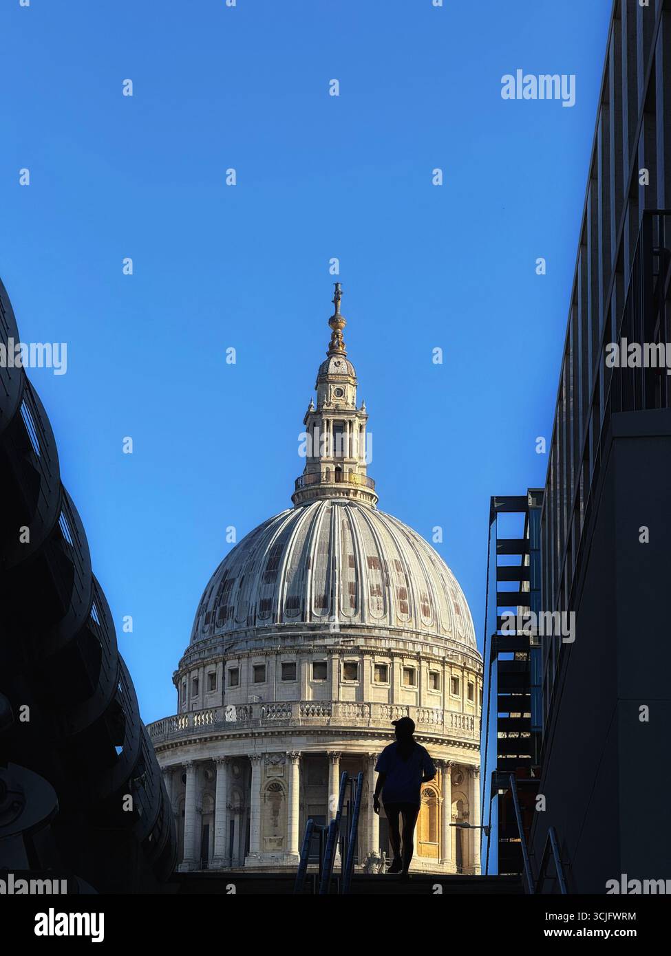 Dome of St Paul’s Cathedral with figure in silhouette in foreground, London - Smartphone Captured Stock Image