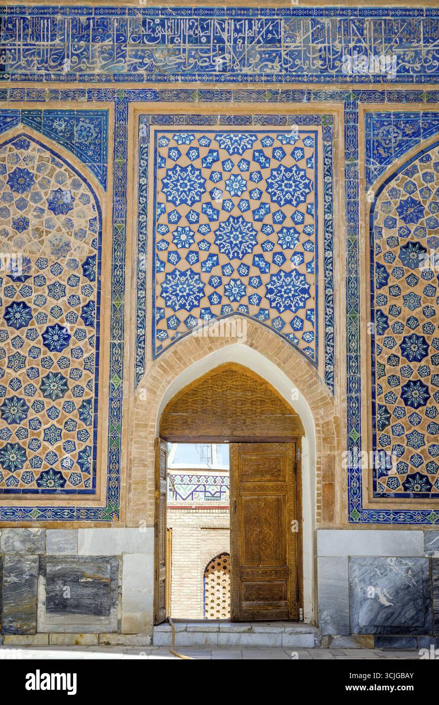 Door in a wall with blue mosaic, Samarkand Registan, Uzbekistan Stock Photo