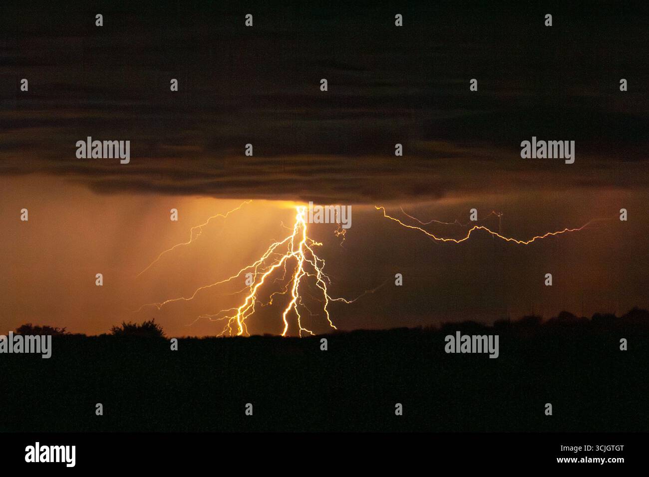 Powerful lighting strikes, thunder and storm in Kgalagadi National Park in South Africa Stock Photo