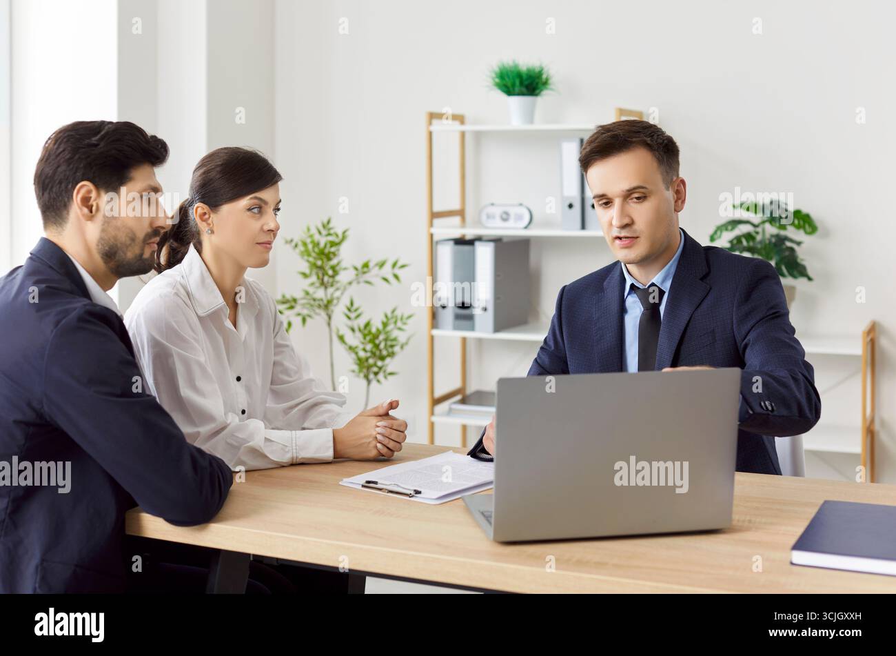 Business people consulting with a young lawyer, close-up Stock Photo