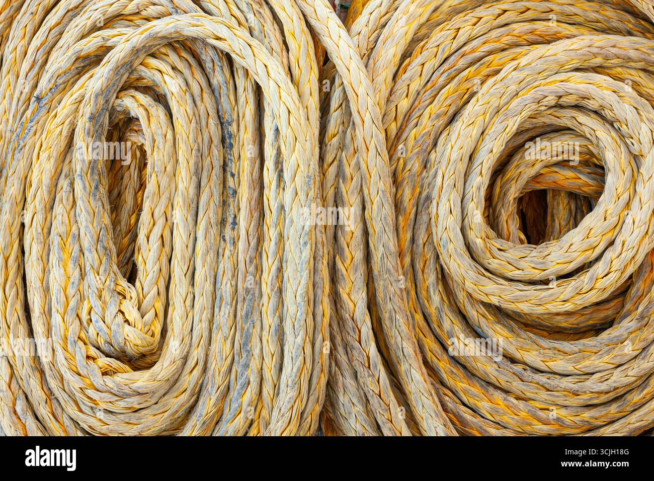 Twisted old synthetic ship's mooring rope, close-up. Stock Photo