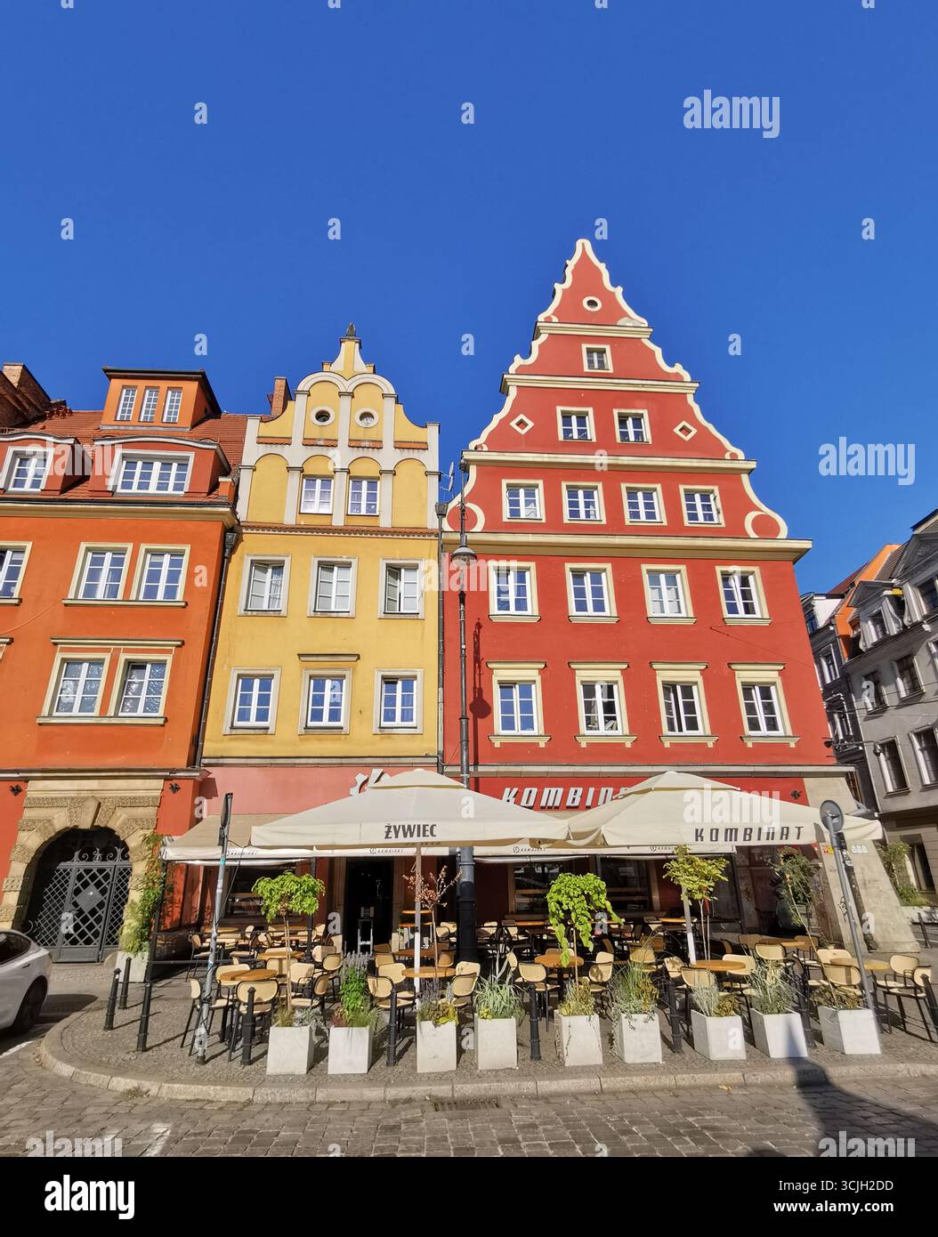 Kombinat,Salt Square (Plac Solny), Wrocław Old Town, Poland—vibrant colourful facade blue skies in Lower Silesia’s colorful medieval market square. - Smartphone Captured Stock Image