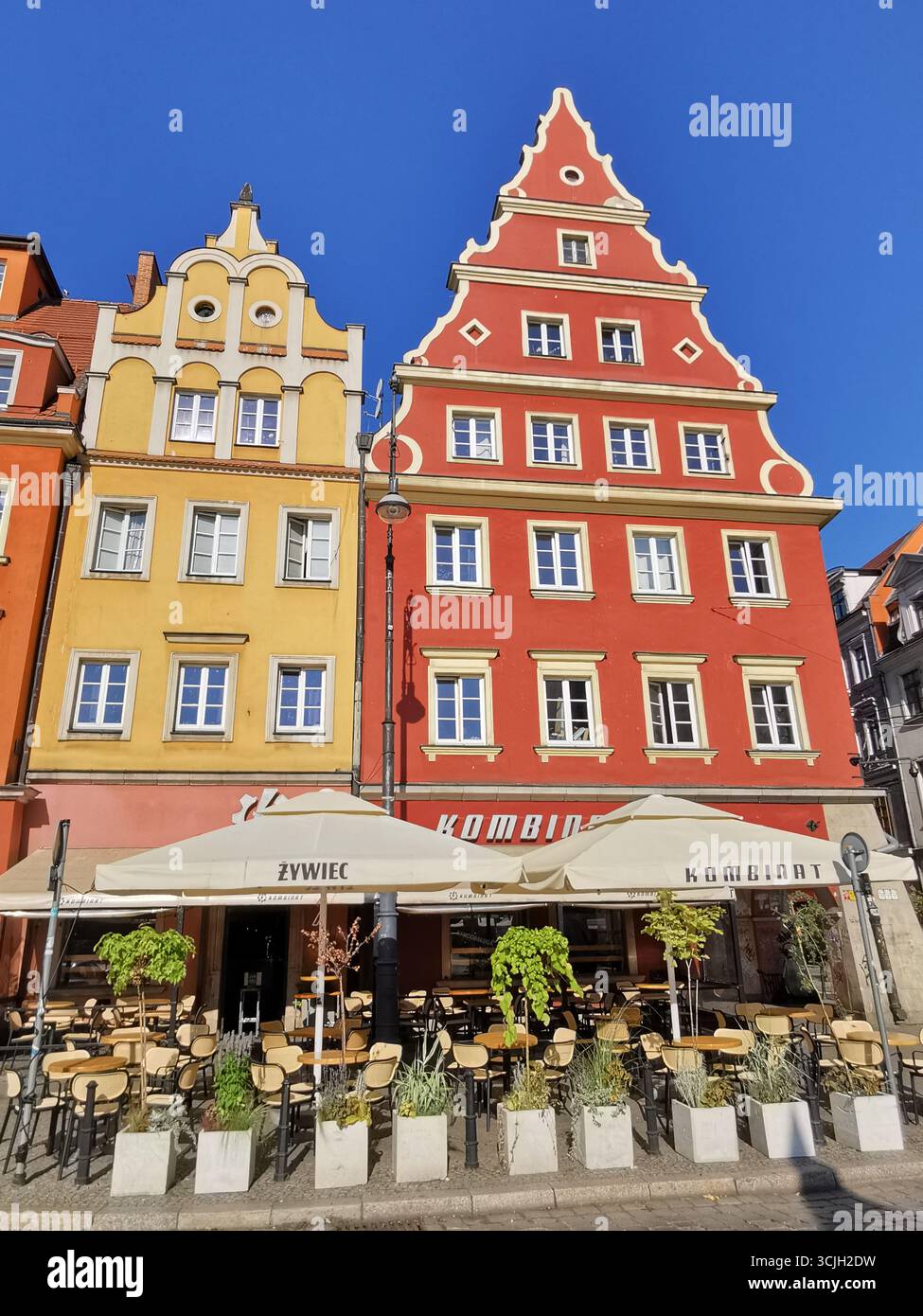 Kombinat,Salt Square (Plac Solny), Wrocław Old Town, Poland—vibrant colourful facade blue skies in Lower Silesia’s colorful medieval market square. - Smartphone Captured Stock Image