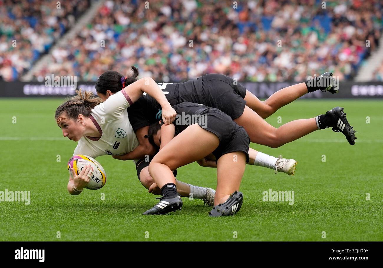 Ireland's Eve Higgins (left) is tackled by New Zealand's Braxton ...