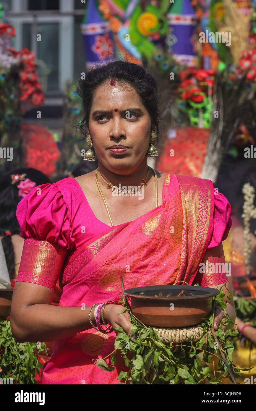 London, UK. 07th Sep, 2025. Participating women in vibrant saris carry offerings of milk in containers on their heads, and burning incense. Hindu devotees, mostly from the Tamil community, take part in the annual Chariot Festival with a vibrant and cheerful procession from the Sivan Kovil Temple through the streets of Lewisham. The deities of Ganesha and Lord Shiva are carried in decorated chariots. Devotees make offerings of milk, burning incense, coconuts or fruit. Credit: Imageplotter/Alamy Live News Stock Photo